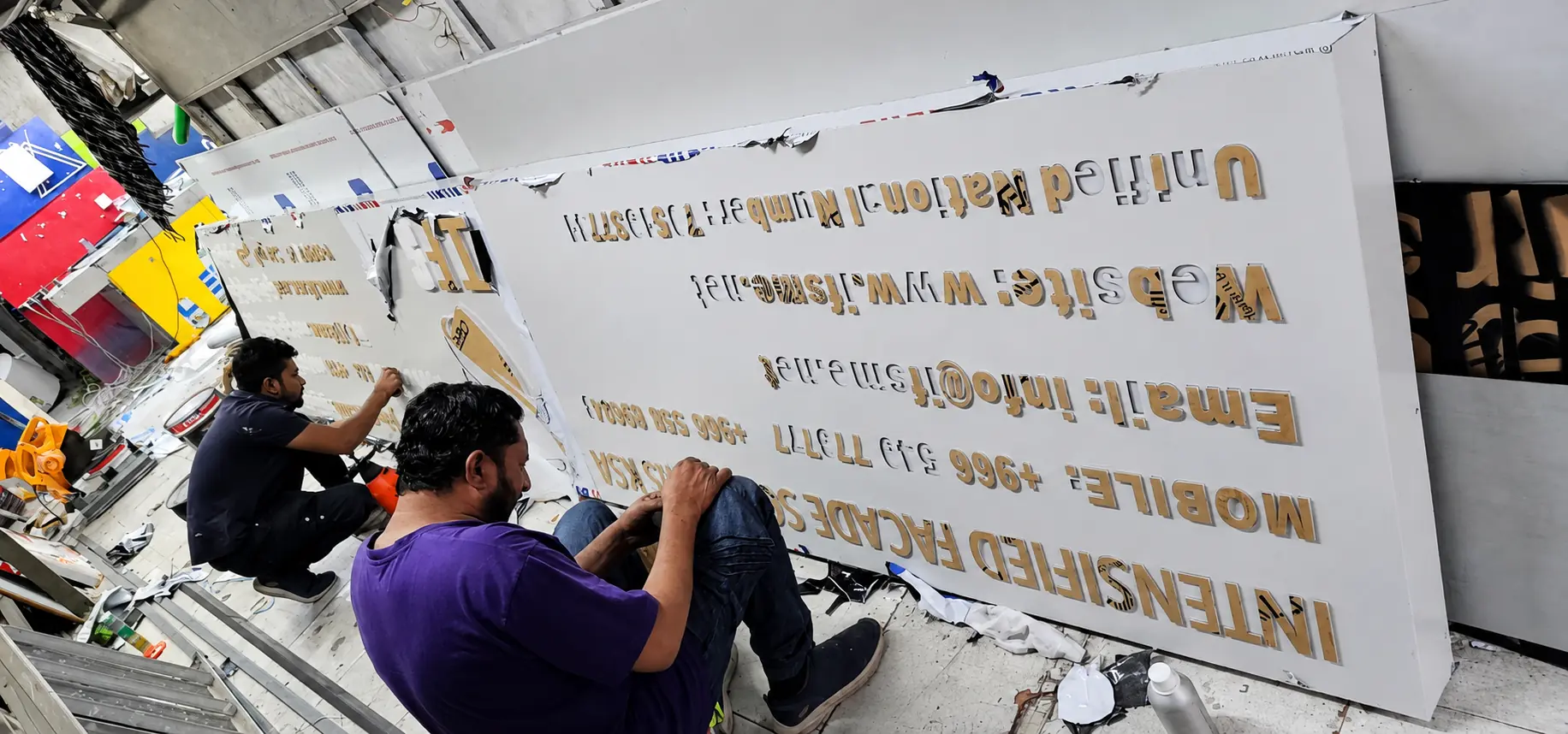 Concept Signage team fabricating a sign inside the workshop